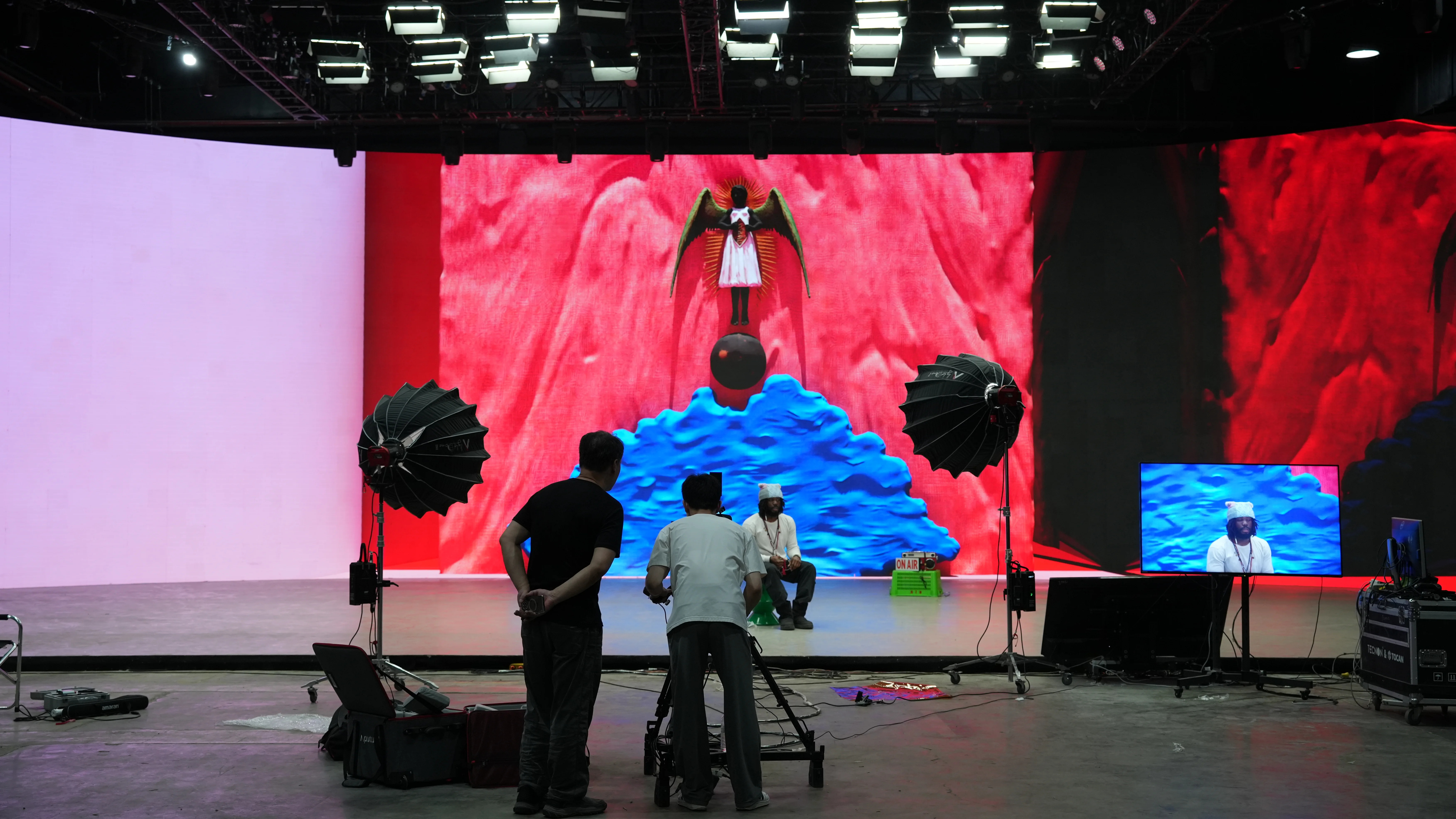 A student filming a music video on a colorful virtual production stage