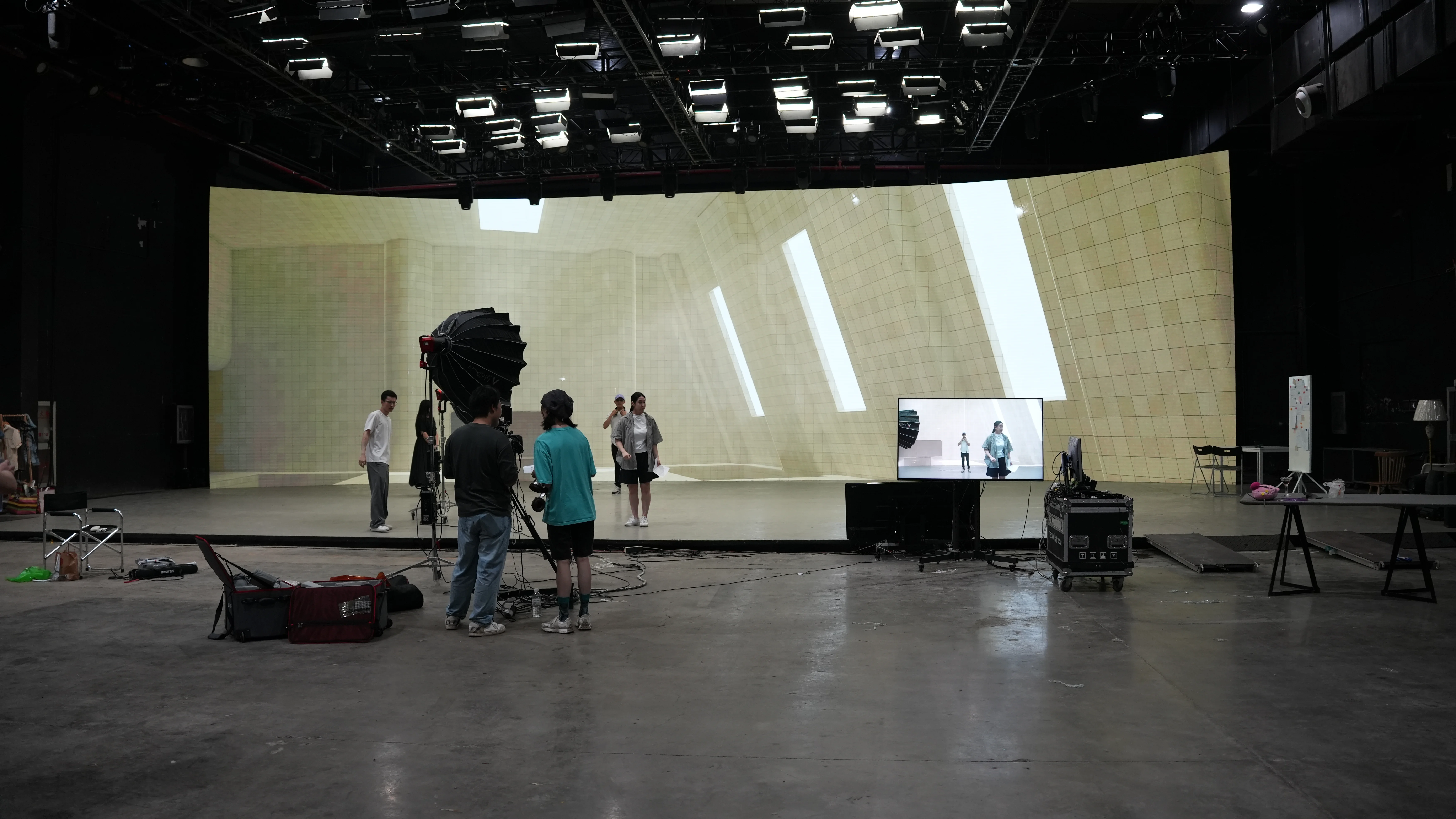 NYU Shanghai students filming in front of a curved LED wall